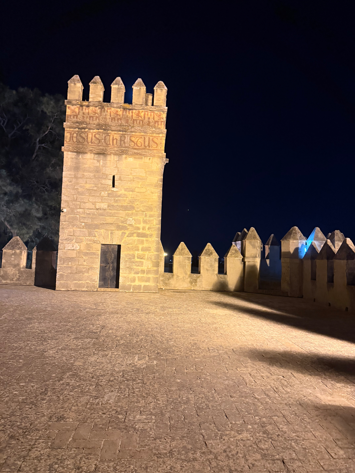 Night view of the Alcázar tower and courtyard in Jerez