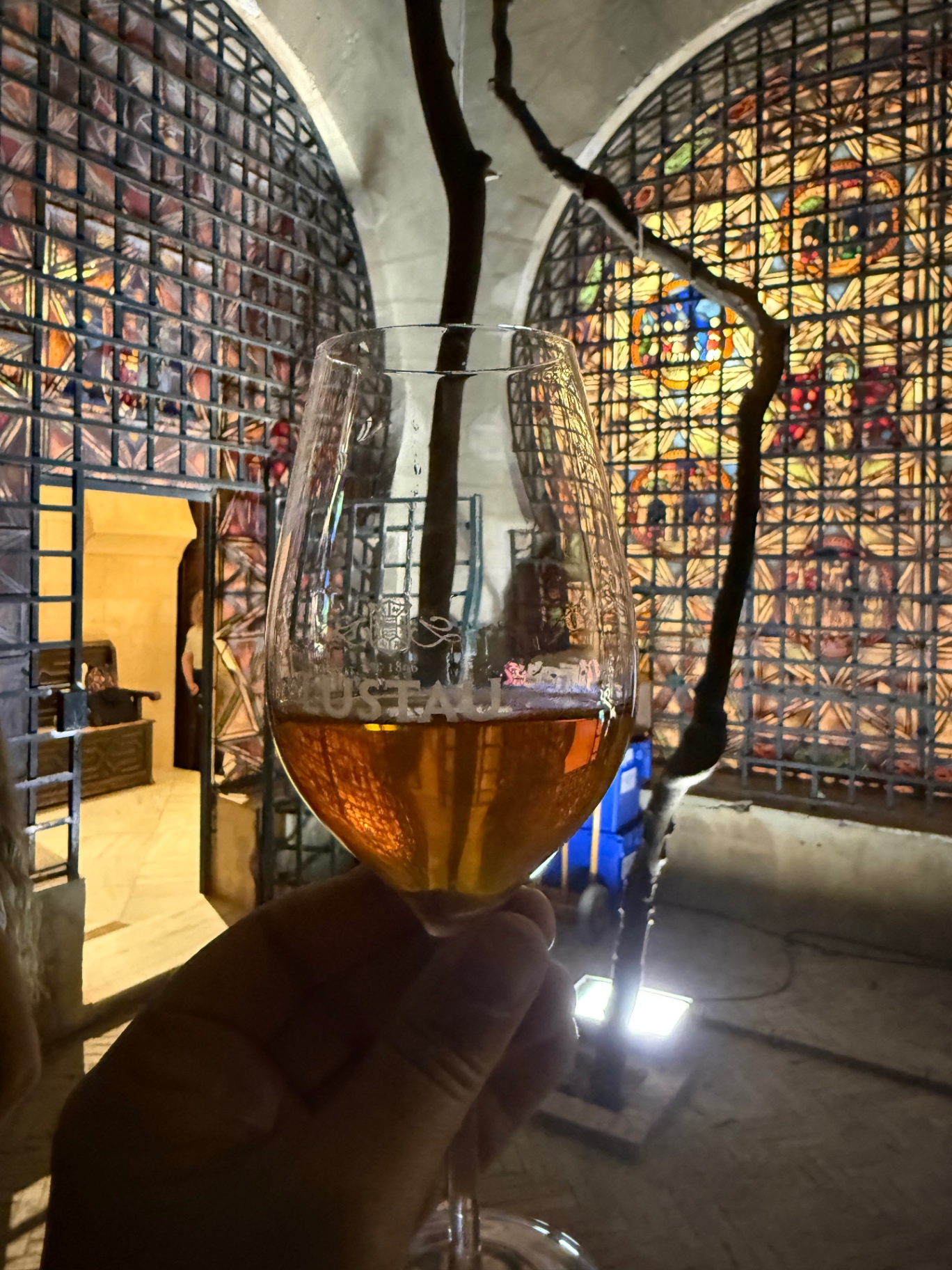 Wine glass in front of stained-glass windows
