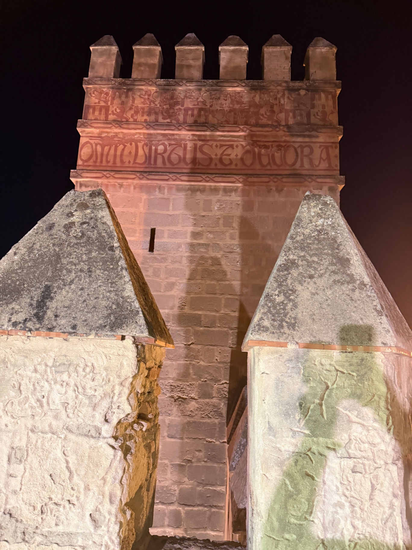 Painted inscription on the illuminated Alcázar tower at night